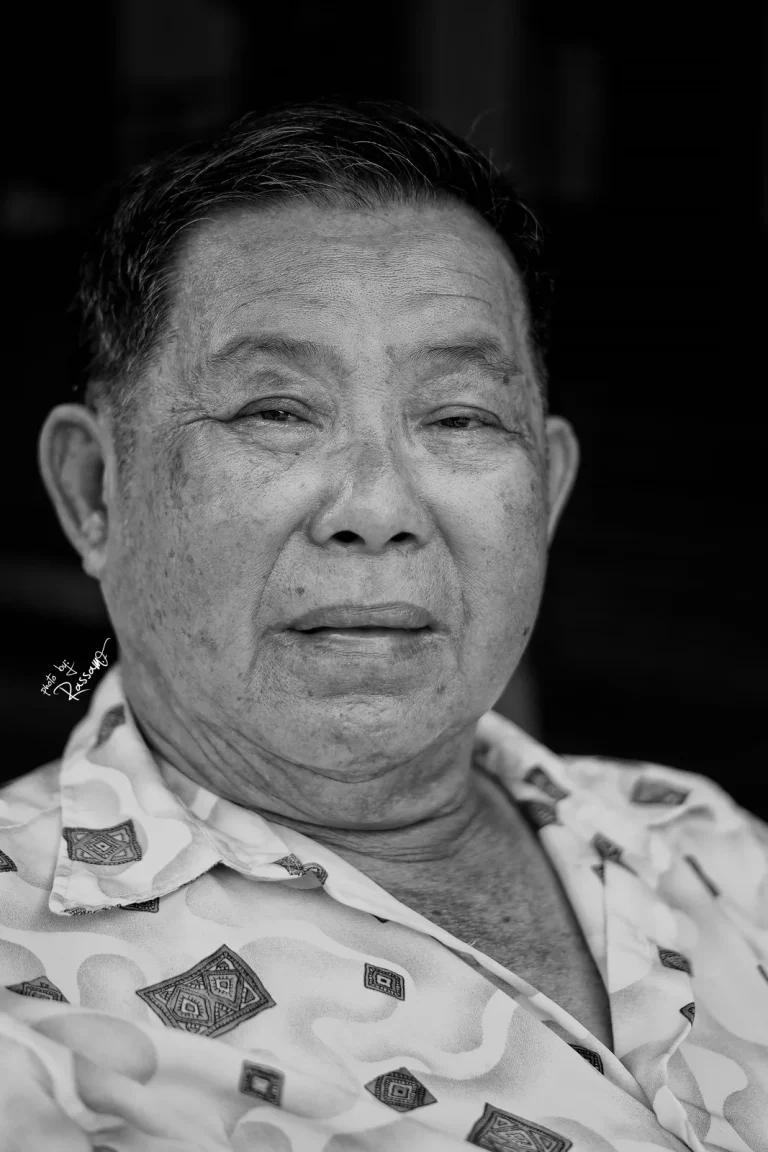 Elderly man in a patterned shirt, black and white portrait