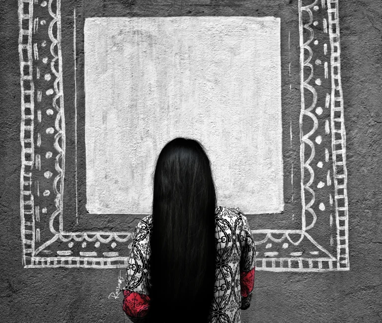 Woman with long black hair facing a blank frame painted on a grey wall