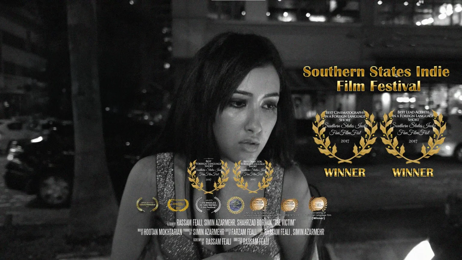 A still from The Victim: the lead actress at night, beside the film’s festival laurels