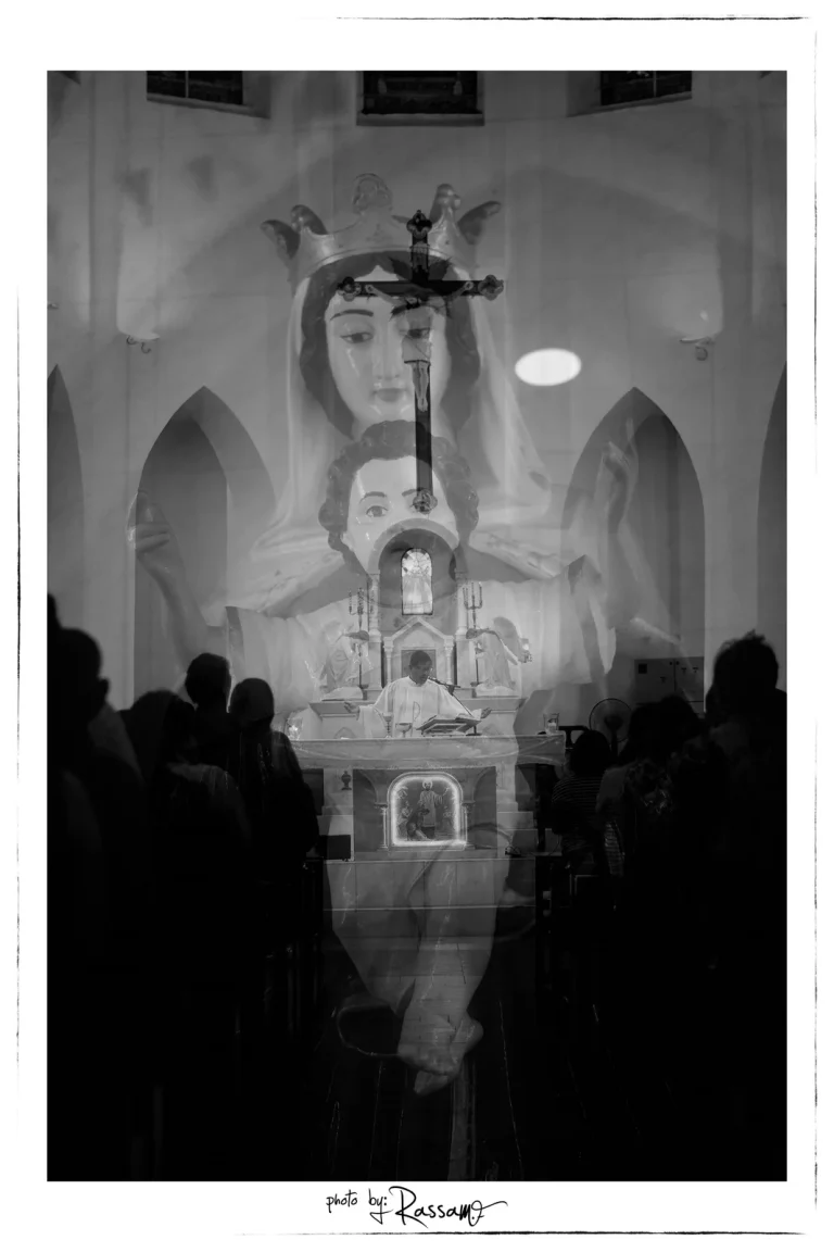 Double exposure of a crowned statue of Mary and Child over the congregation and the altar, black and white
